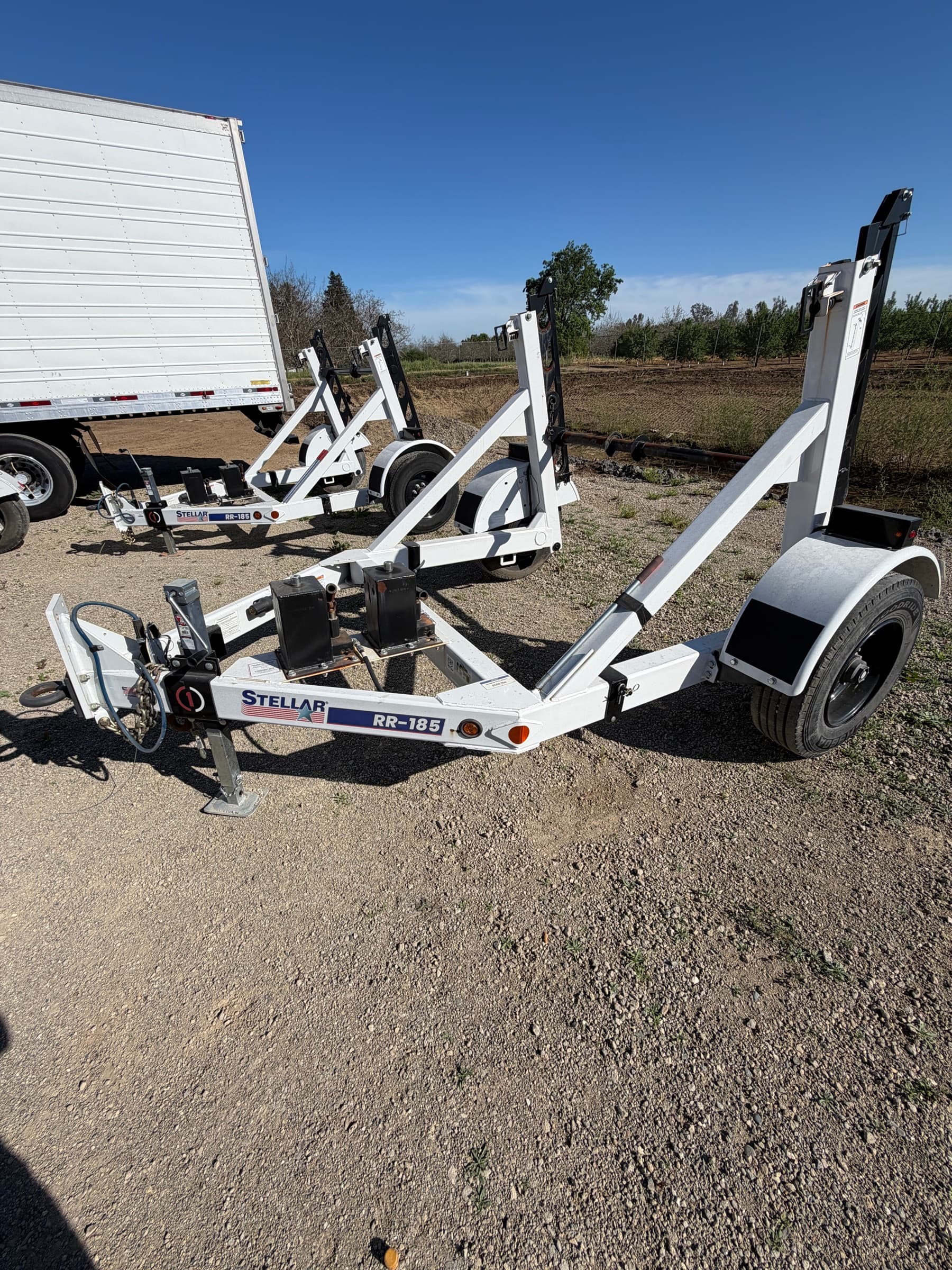 Stellar RR-185 reel trailer with its road wheel and fender in the foreground, further units parked behind